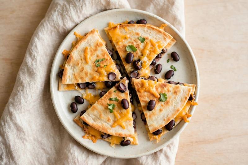 Photo of Black Bean & Cheese Quesadilla Triangles, a snack recipe from FluentFuel
